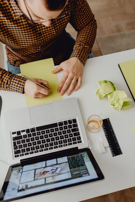 A clean and modern workspace featuring a laptop, tablet, smartphone, and monitor. Ideal for remote work and tech setups.